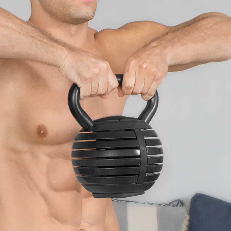 Man holding a black textured kettlebell against a plain background