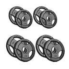 Set of four weight plates with different weights on a white background