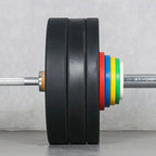 Barbell with weight plates and colorful sleeves on a gray background