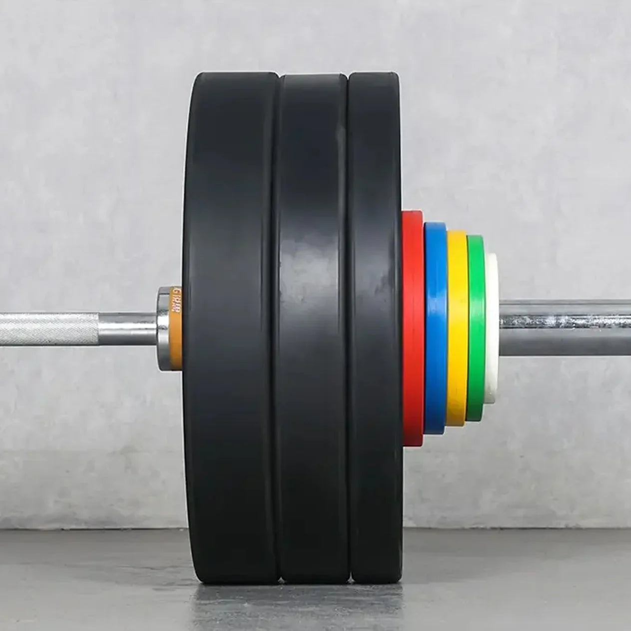 Barbell with weight plates and colorful sleeves on a gray background